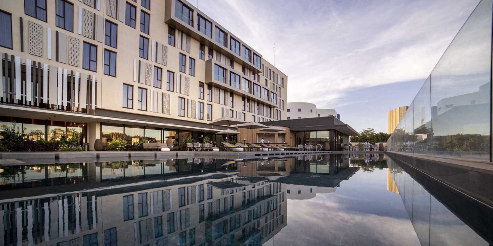 a large building with a swimming pool in front of it