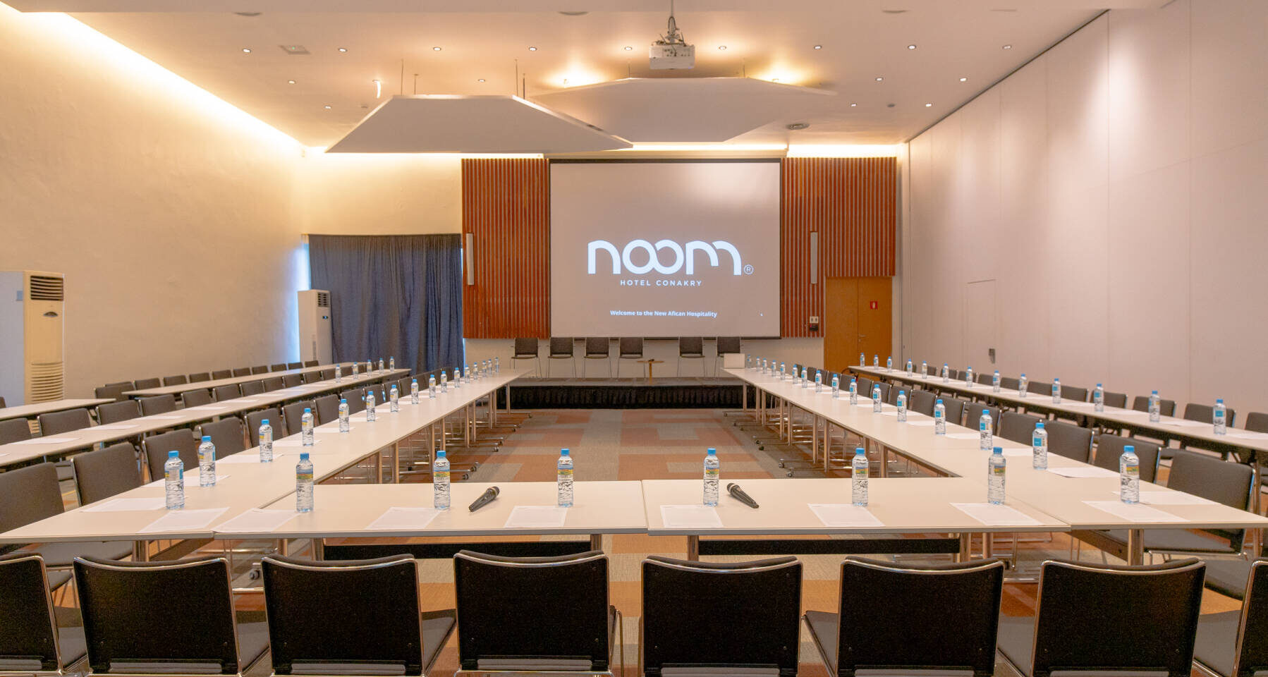une salle de conférence avec une table blanche et des chaises