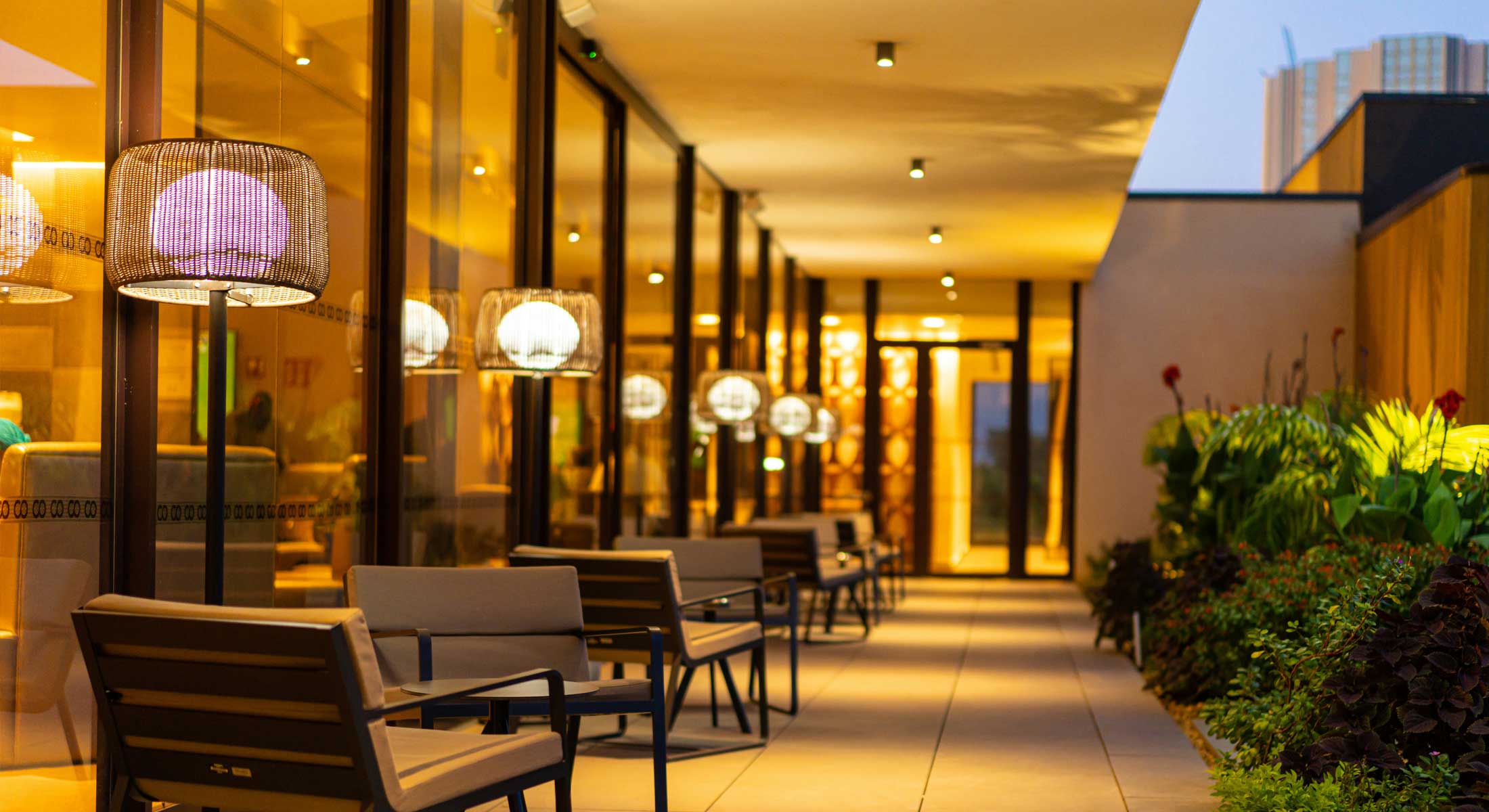 a row of chairs and tables are lined up on a patio