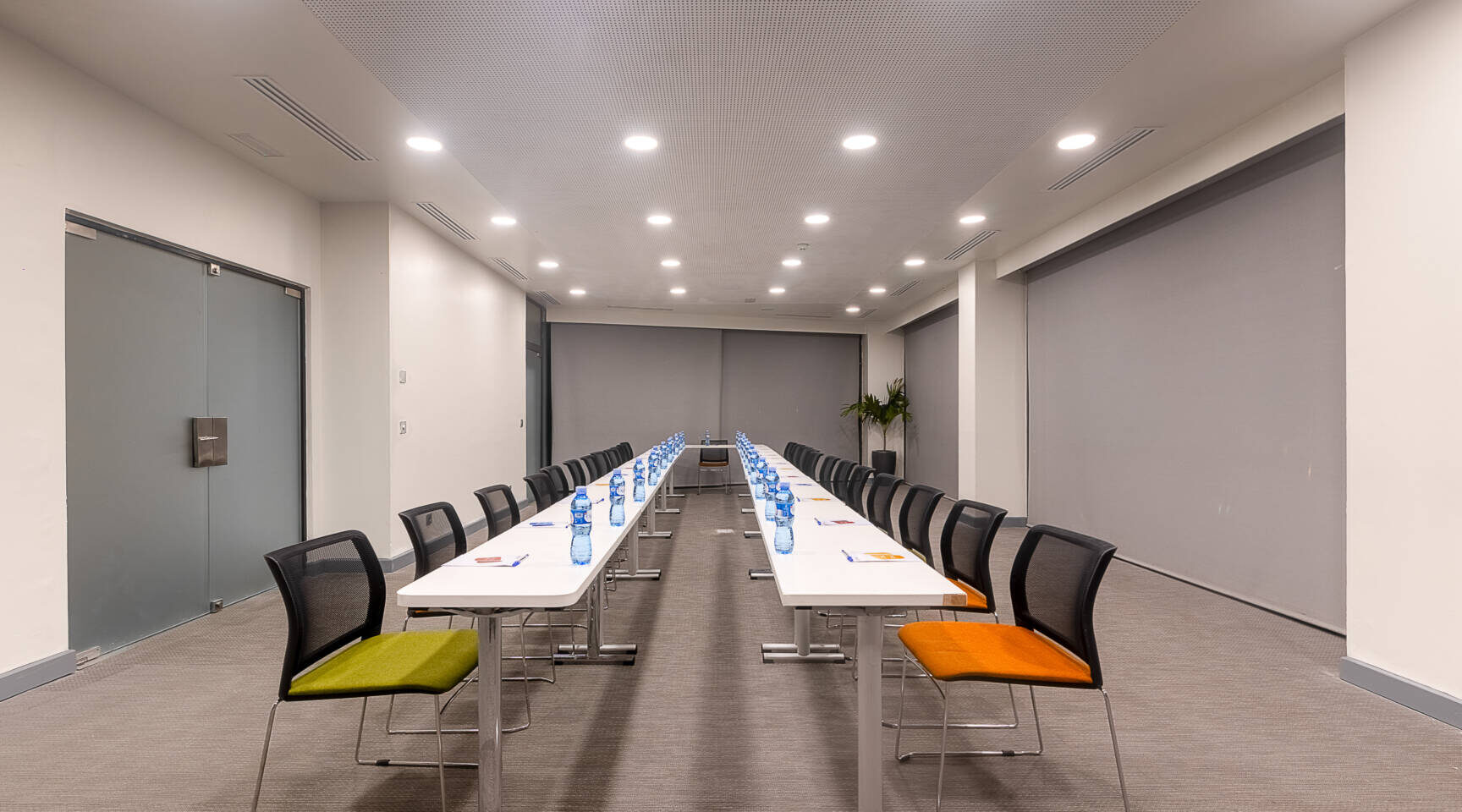 a conference room with a screen that says