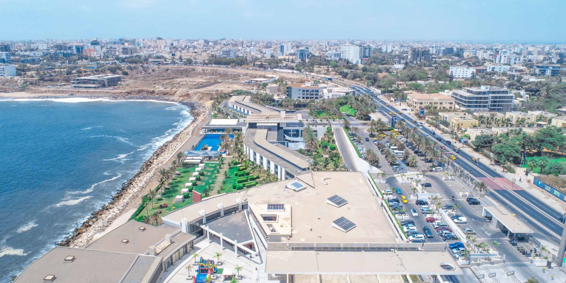an aerial view of a city with the ocean in the background