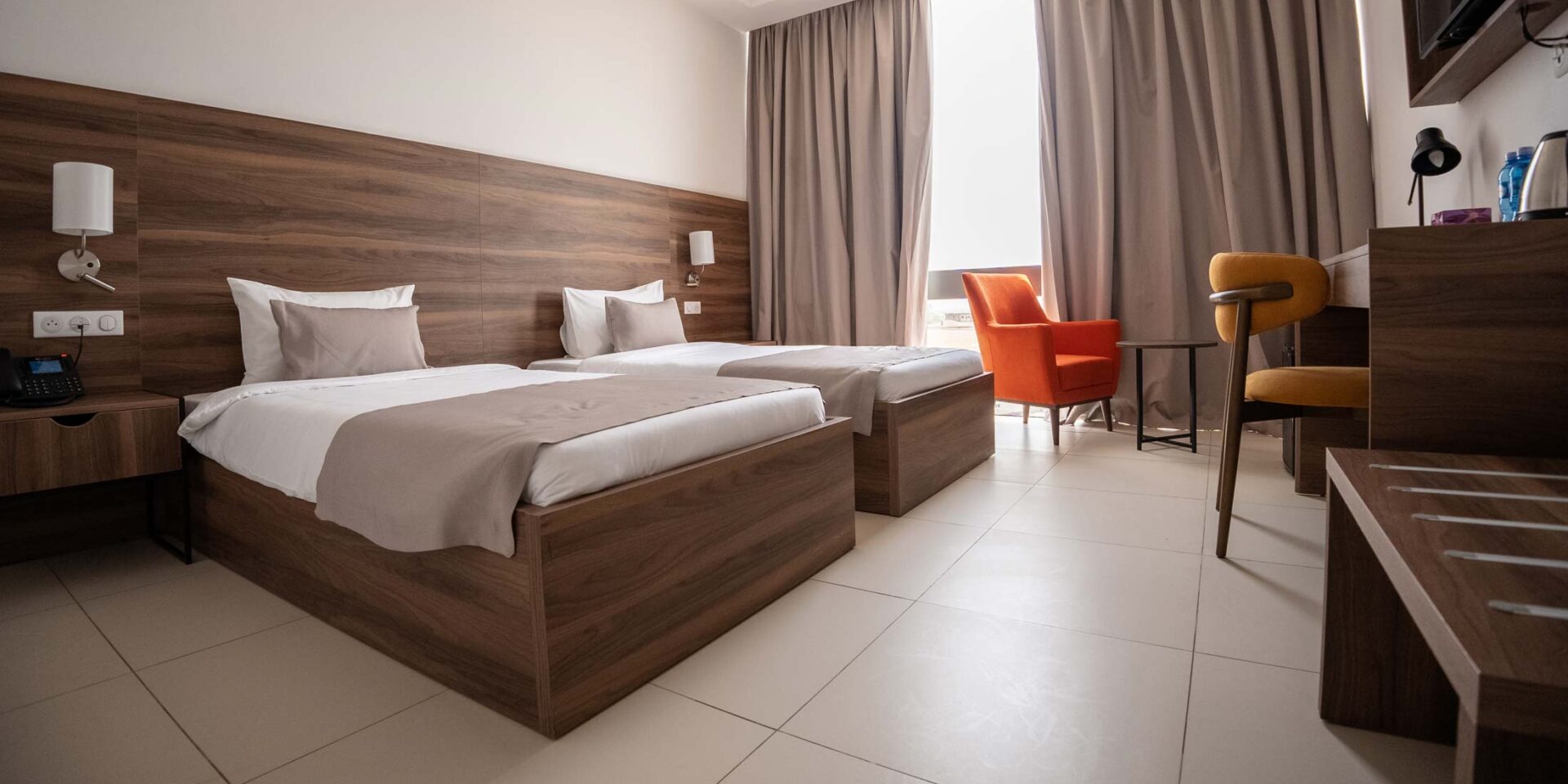 a hotel room with two beds and a chair