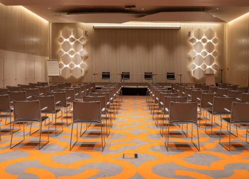 rows of chairs are lined up in a conference room