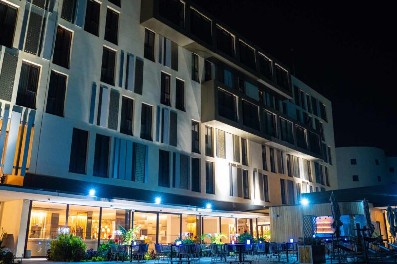 a large building with a lot of windows is lit up at night