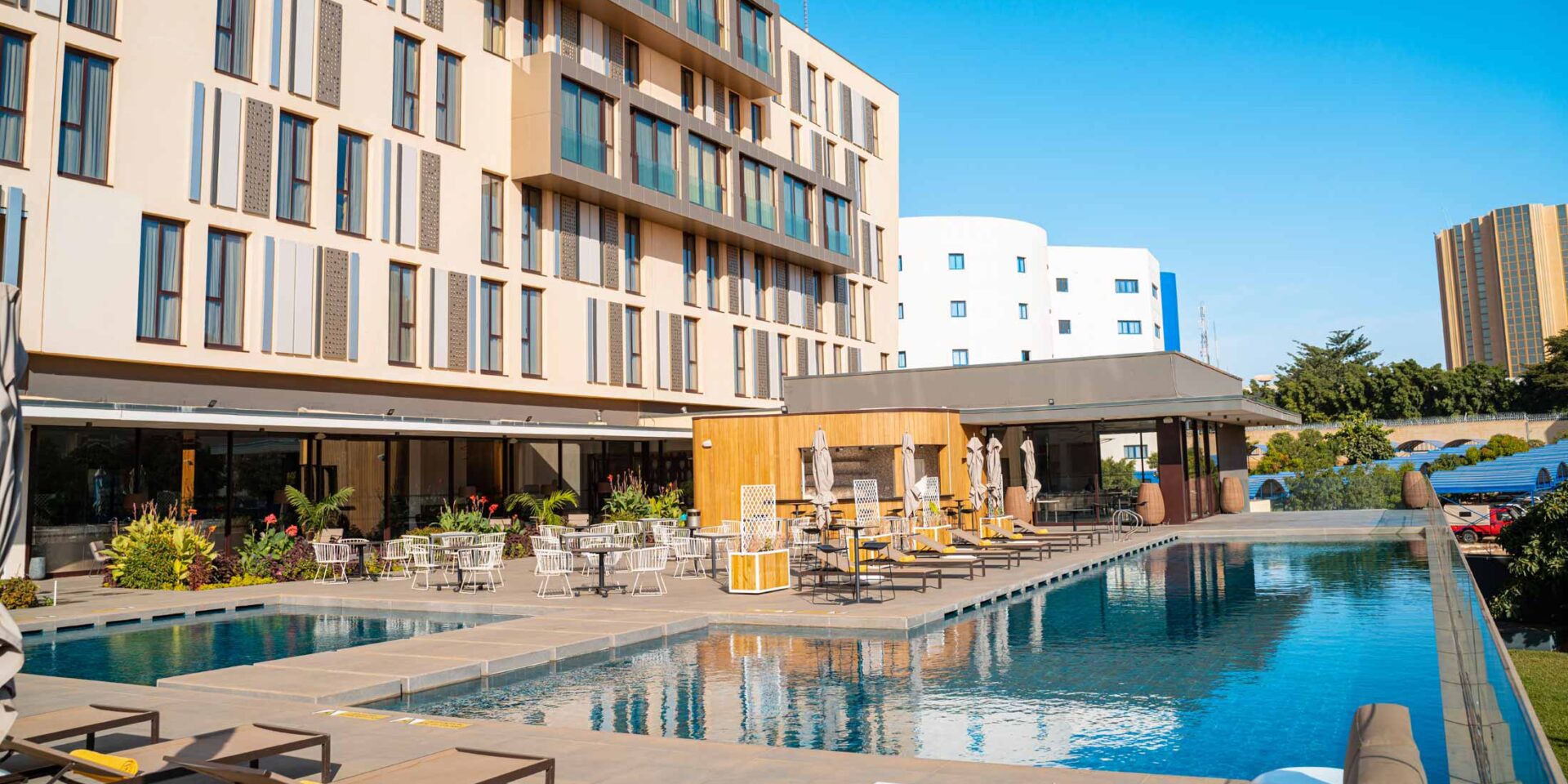 a large building with a swimming pool in front of it