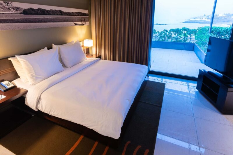 a hotel room with a large bed and a flat screen tv