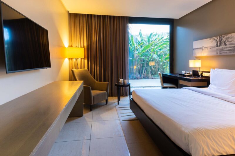 a hotel room with a large flat screen tv on the wall