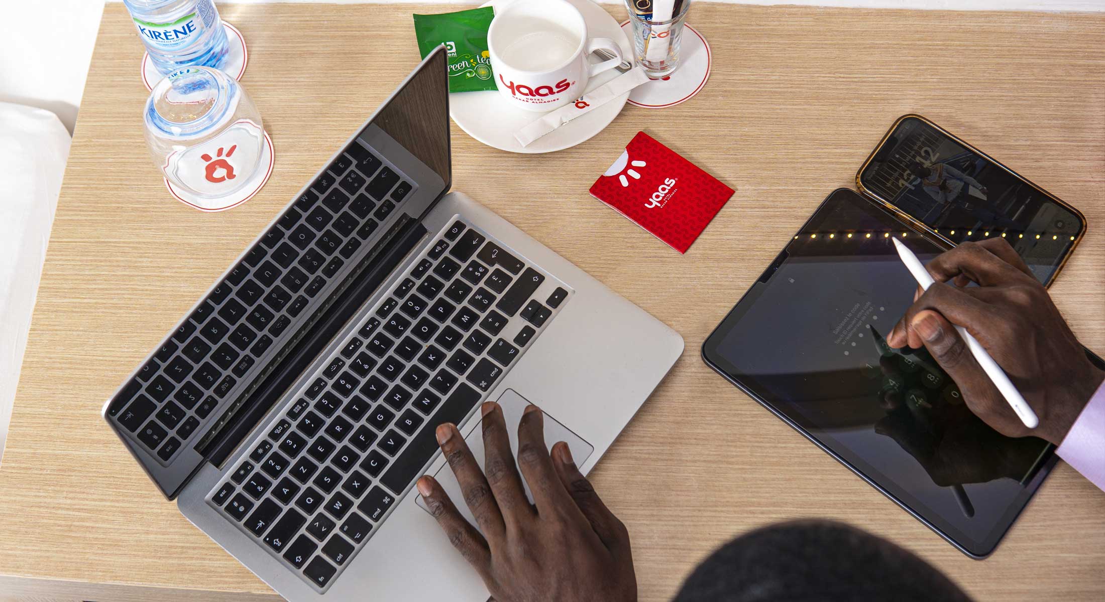a person using a laptop next to a card that says 