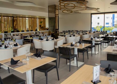 a restaurant with tables and chairs and a sign that says ' a ' on it