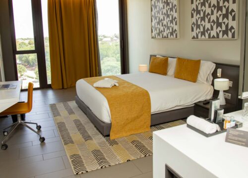 a hotel room with a large bed and a desk