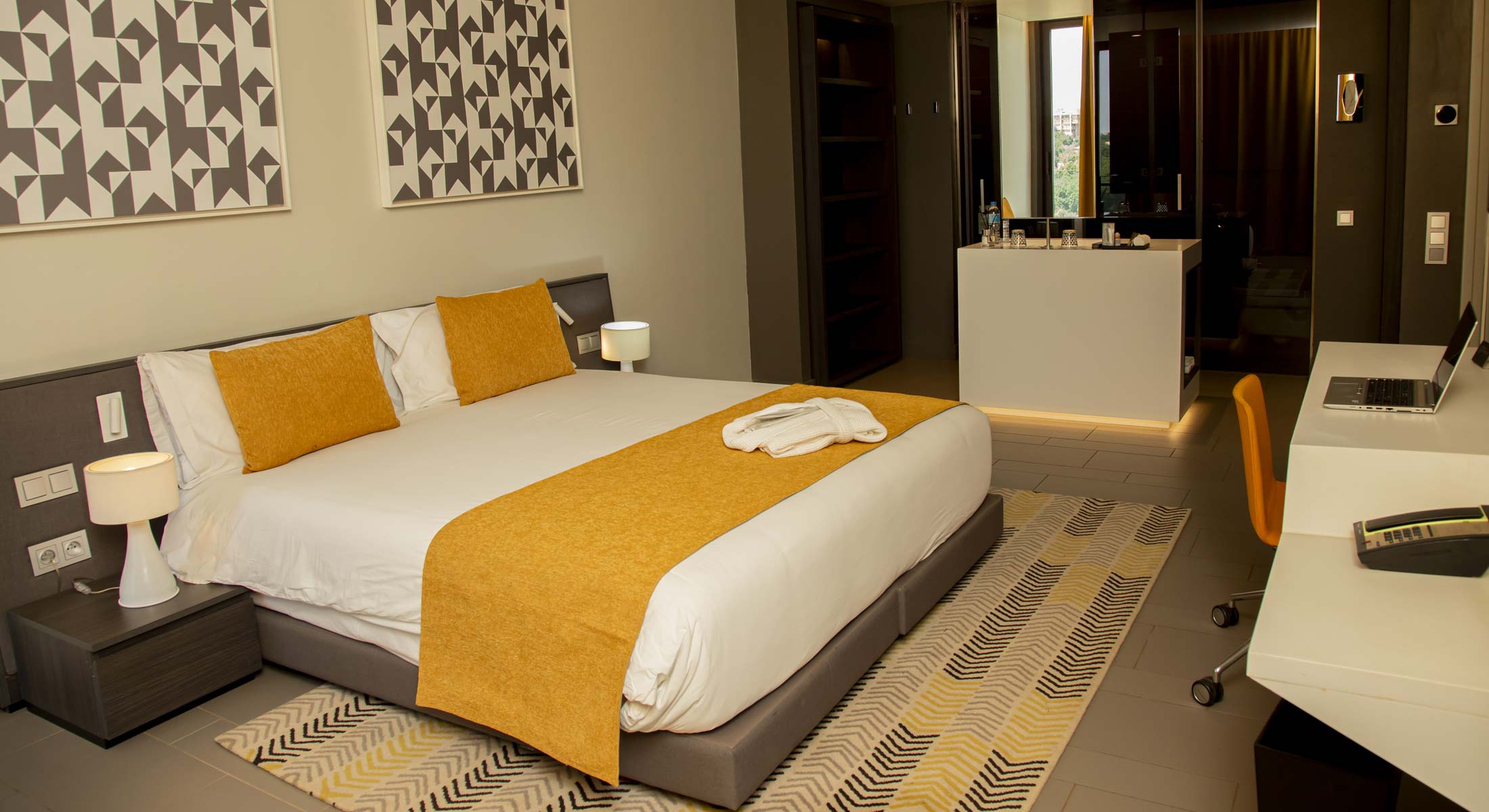 a hotel room with a large bed and a desk