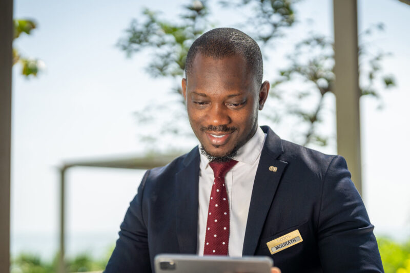 a man wearing a name tag that says receptionist