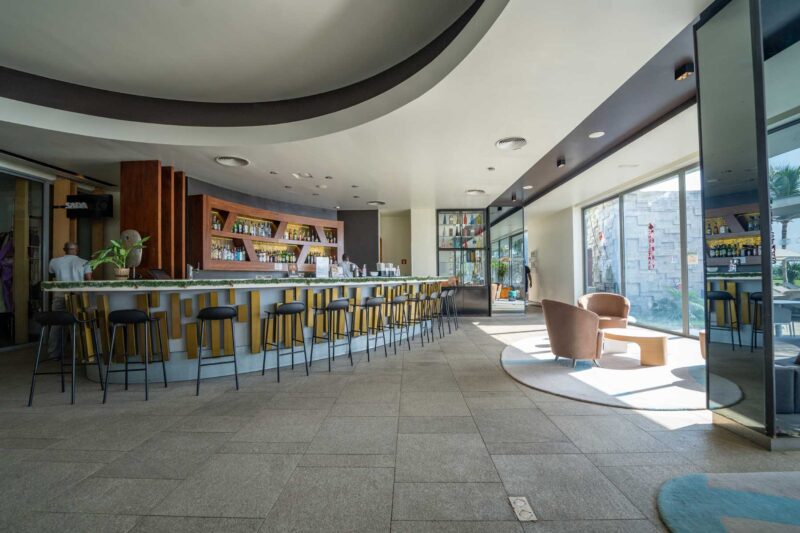 a bar in a hotel with a sign that says ' aqua ' on it