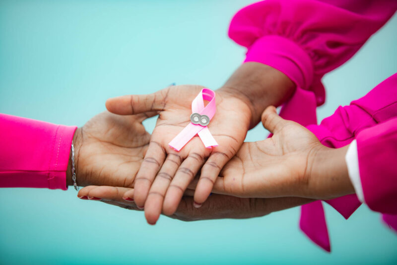 Pink october with women's hands