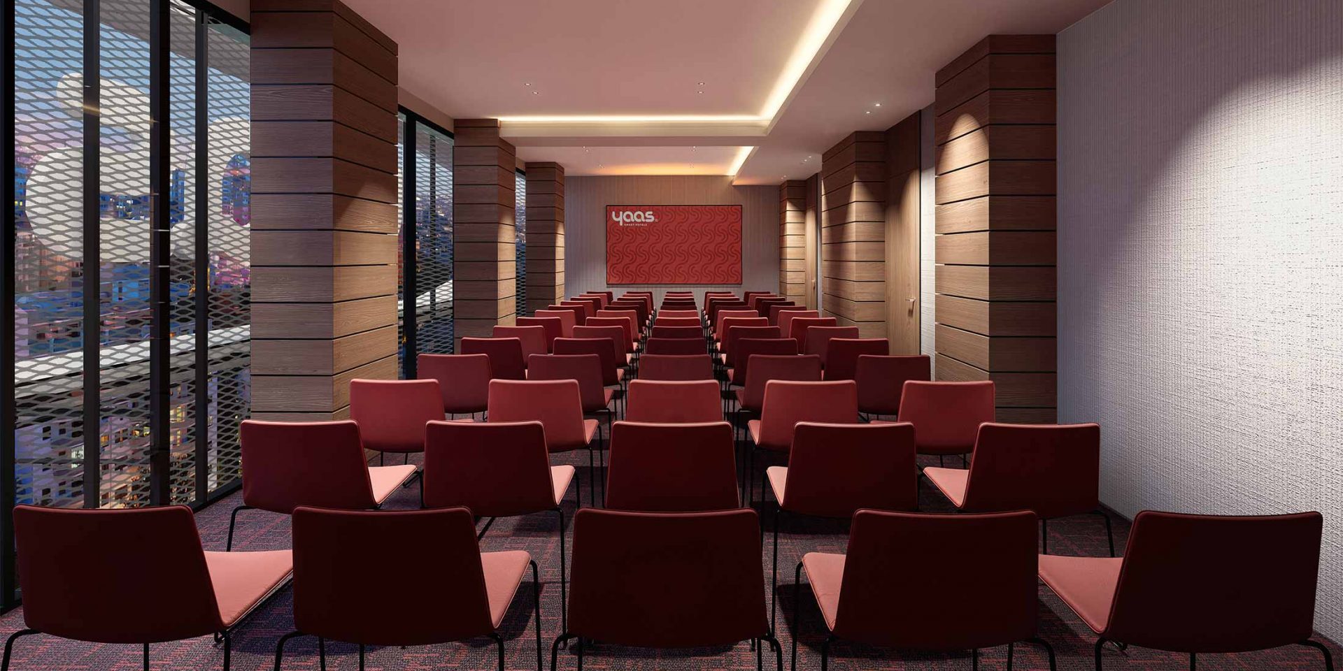 Conference room with rows of red chairs facing a presentation screen.