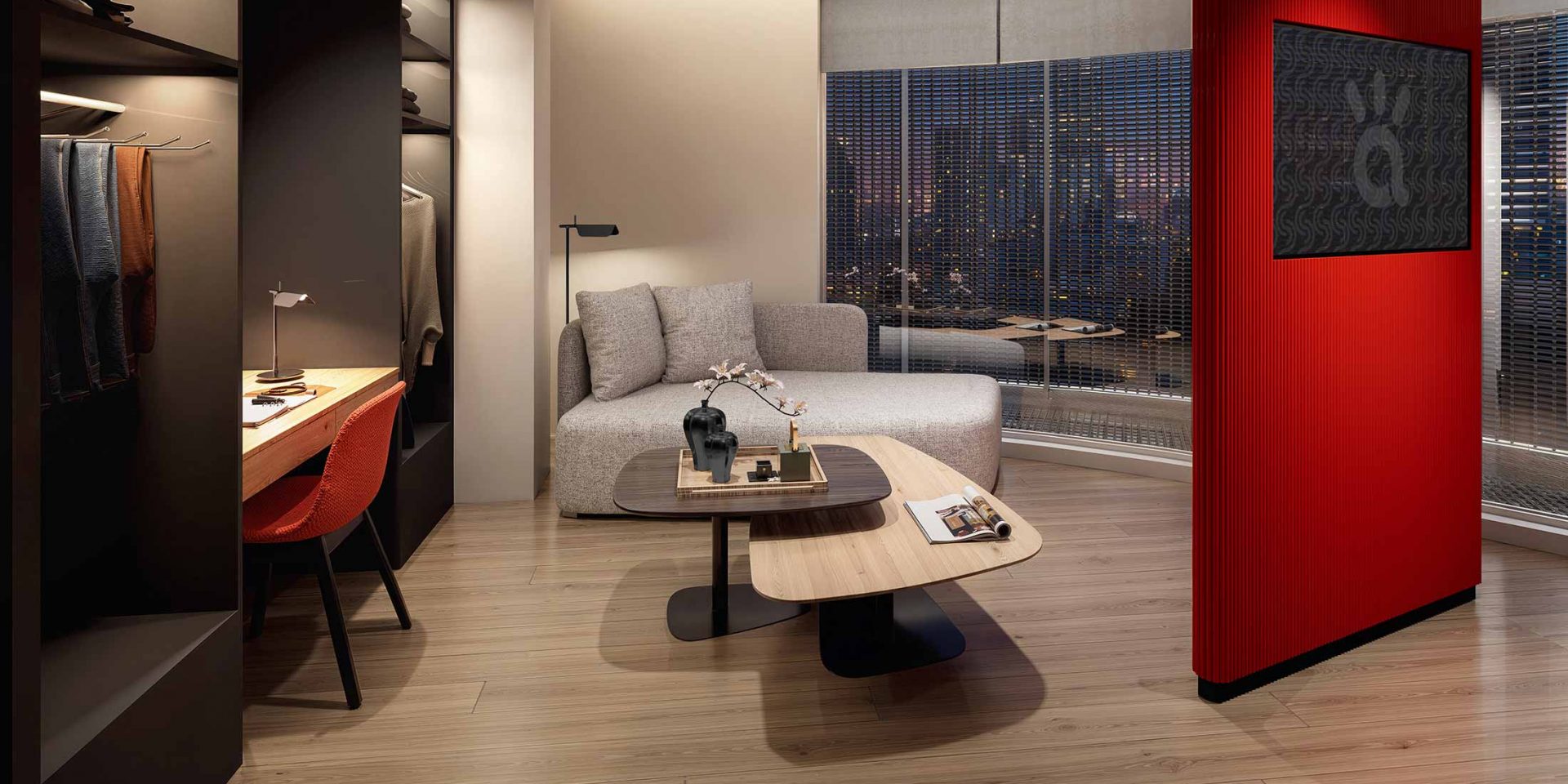 Modern hotel room with a grey daybed, nesting coffee tables, and a city view.
