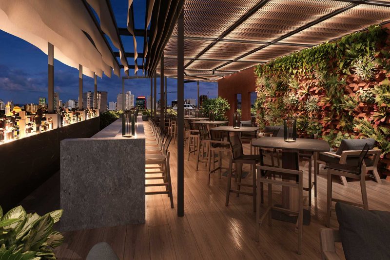 Modern rooftop bar with seating, a living plant wall, and city views at dusk.